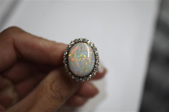 An 18ct gold, white opal and diamond oval cluster ring, size N.
